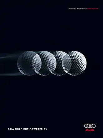 four golf balls next to Audi Logo